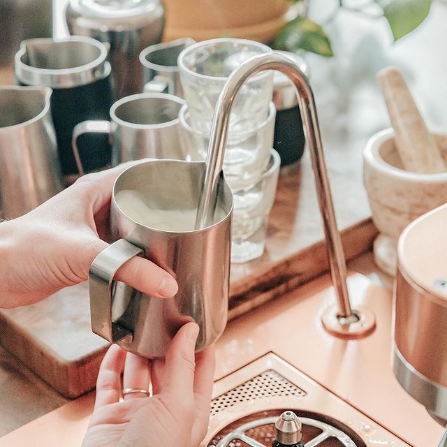 milk being frothed at by a barista