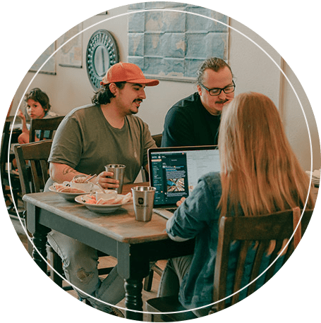 Image: Happy cafe customers work while eating and drinking